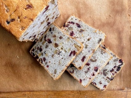 Tuscan Coffeecake baked in a loaf pan, then sliced on a board.